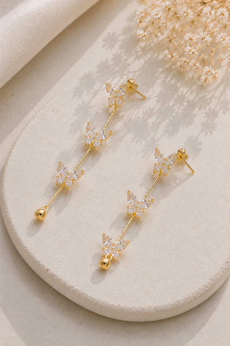 Butterfly Whisper Earrings, crystal butterfly stud with chain drop, gold-tone stainless steel
