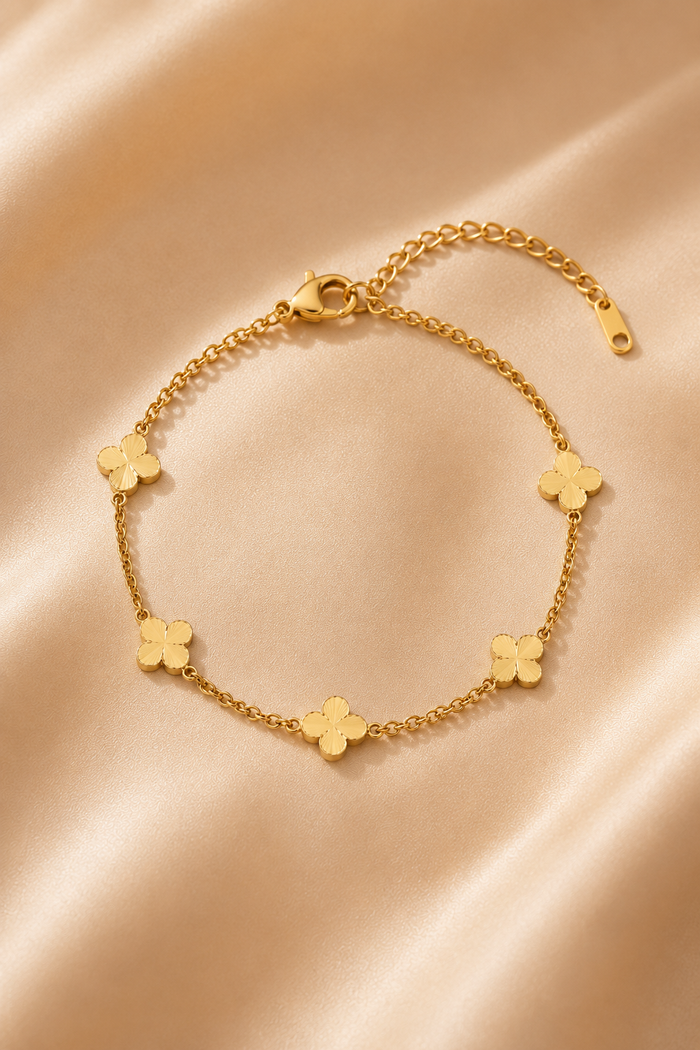 Clovera Charm Bracelet, polished four-petal stations in gold-tone stainless steel