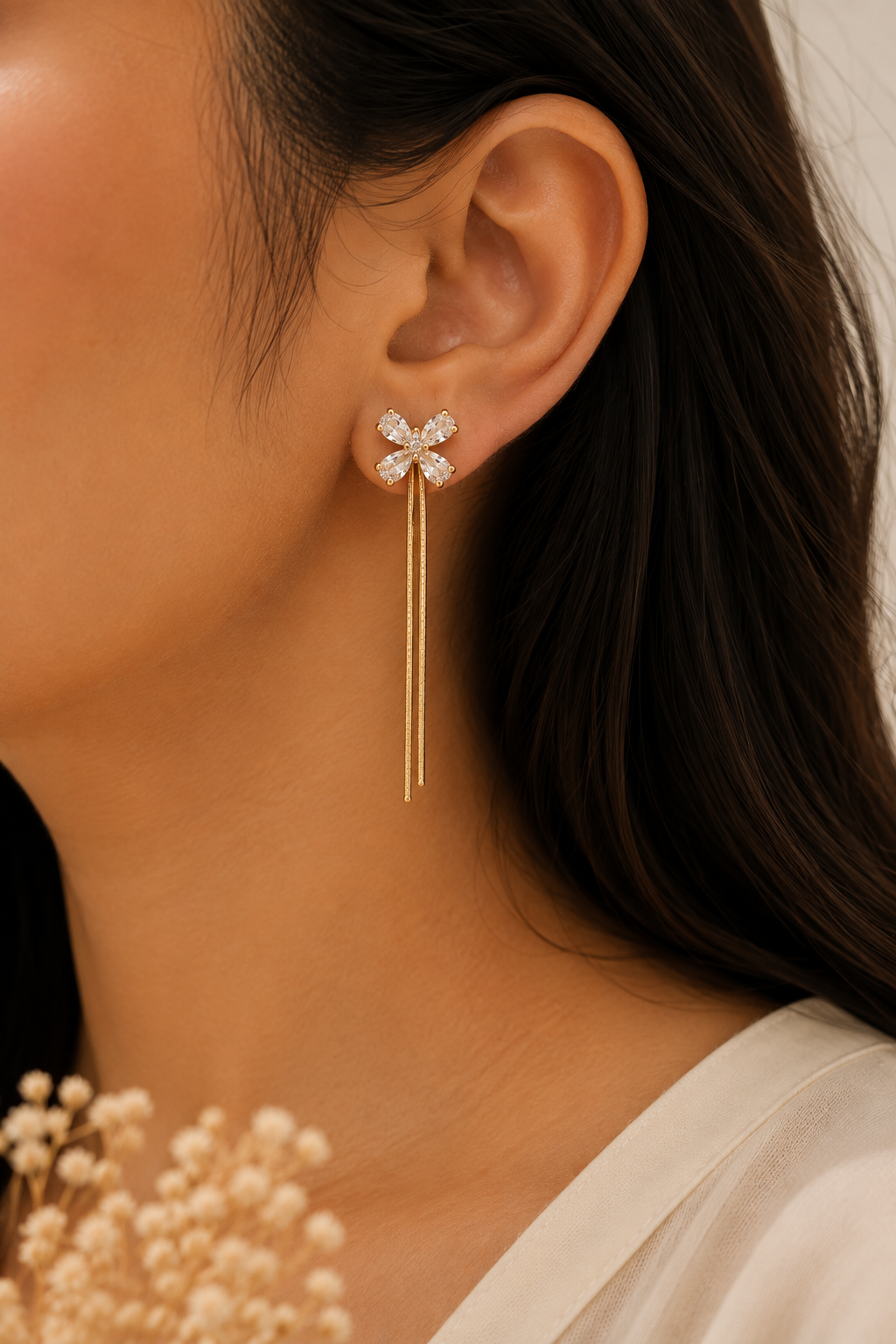 Crystal Bloom Earrings worn on the ear, butterfly threader with a chain drop behind
