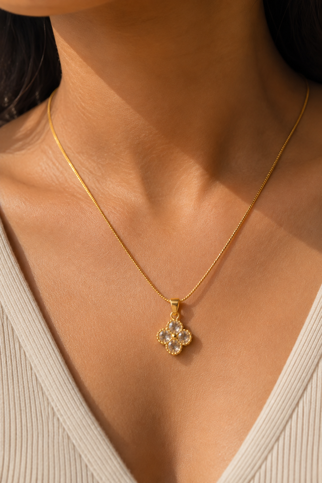 Crystal Clover Necklace worn at the neck, small four-stone pendant on a fine chain