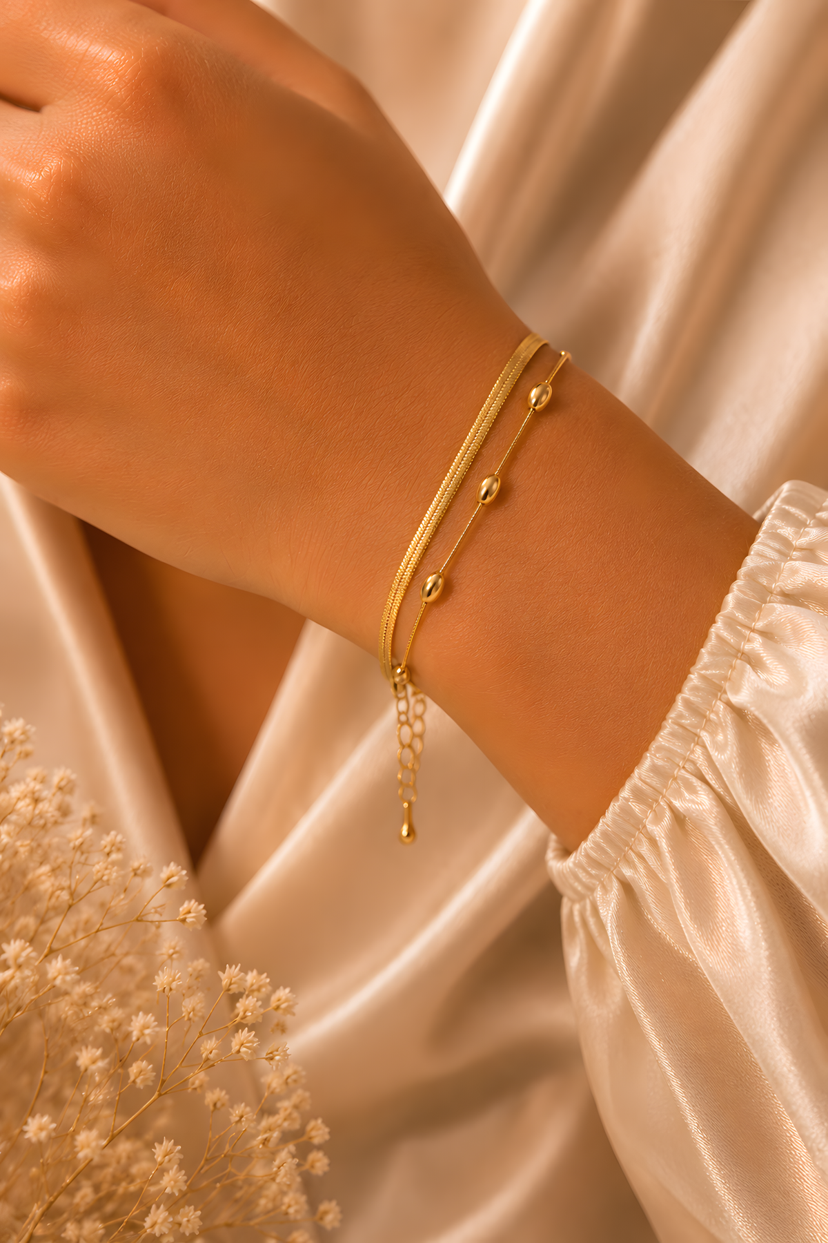 Gold Layered Chain Bracelet worn on the wrist, herringbone chain beside a fine beaded chain