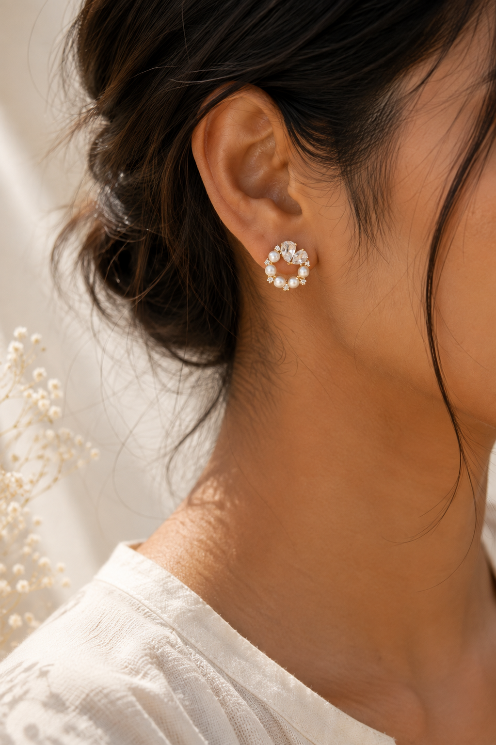 Golden Pearl Wreath Earrings worn on the ear, open circle of pearls and crystal hearts