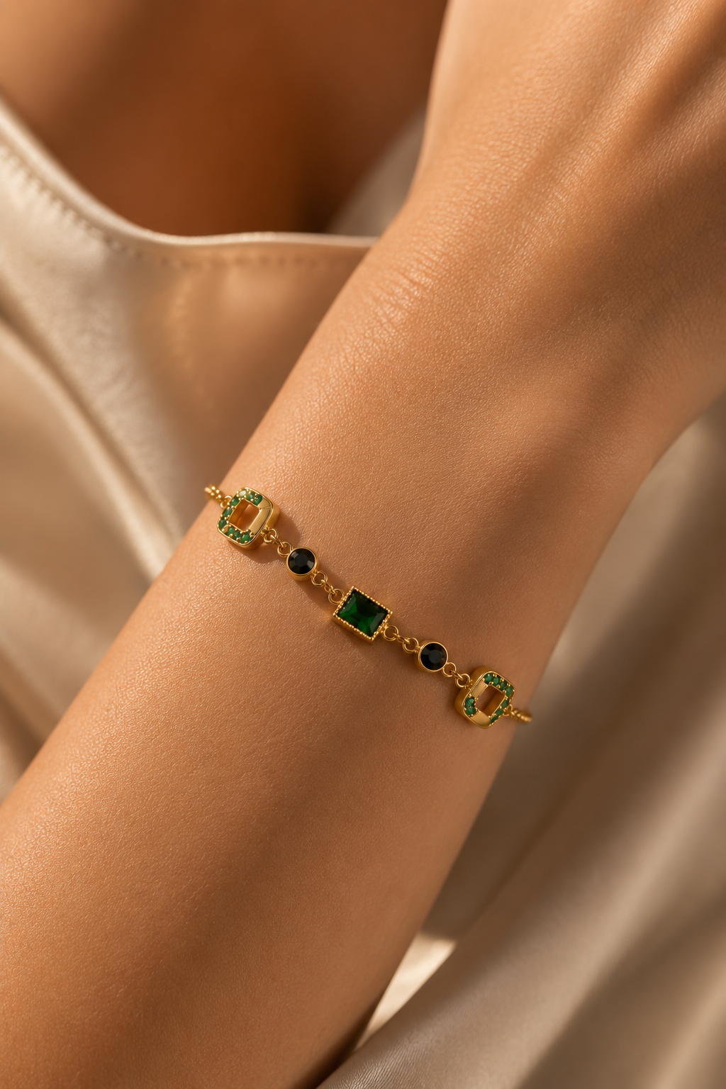 Green Stone Station Bracelet worn on the wrist, deep green stones set along a fine chain