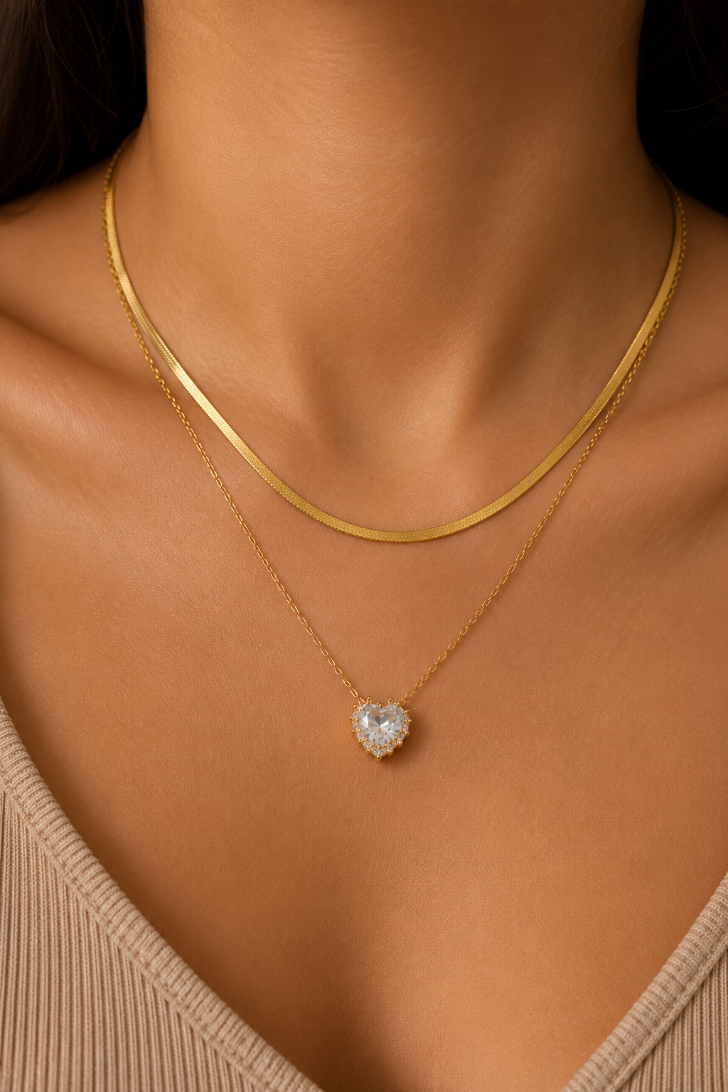 Heart Layered Pendant worn at the neck, herringbone chain layered with a halo stone pendant