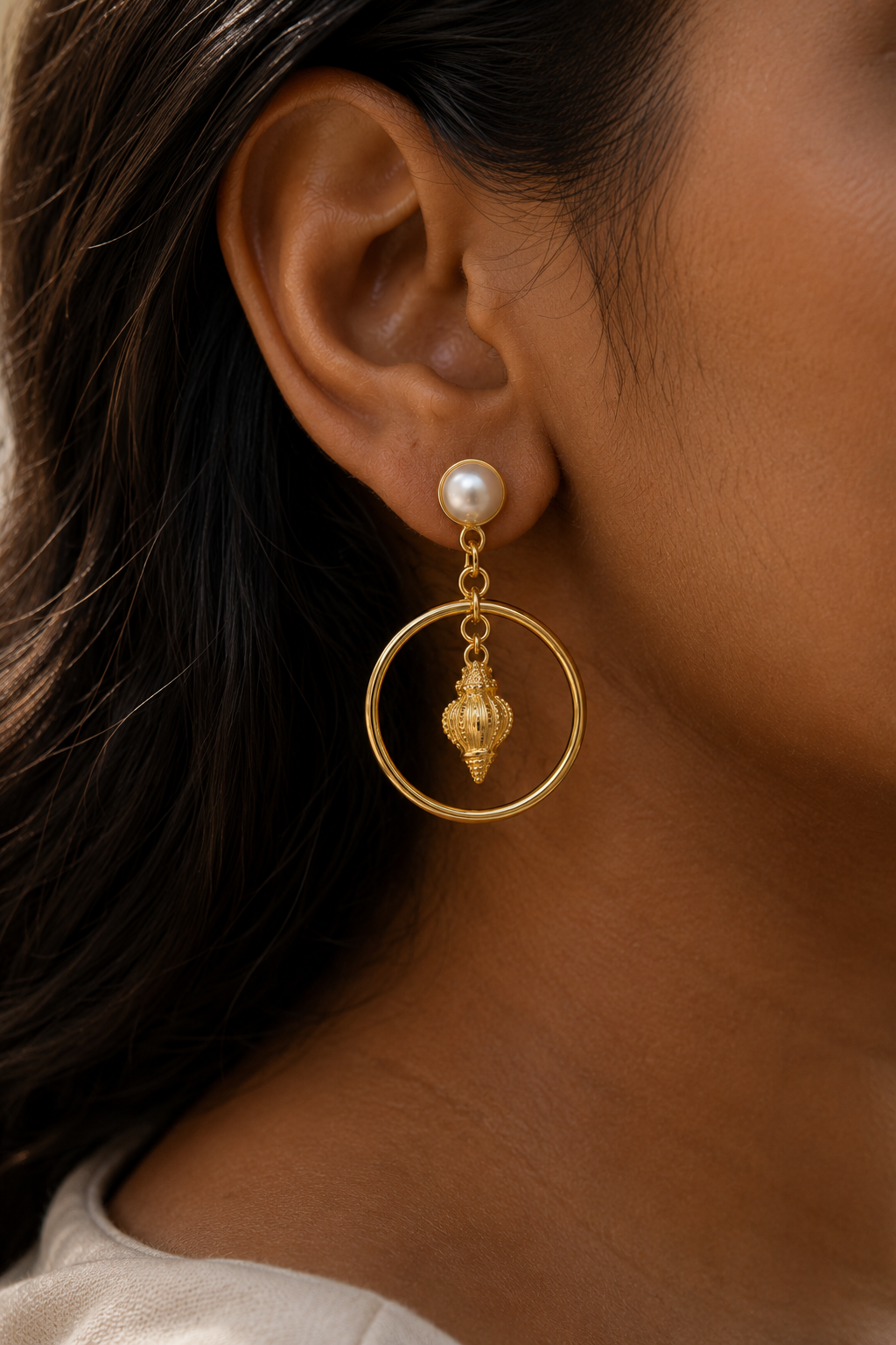 Seashell Pearl Drop Earrings worn on the ear, pearl stud above a hoop with a shell charm