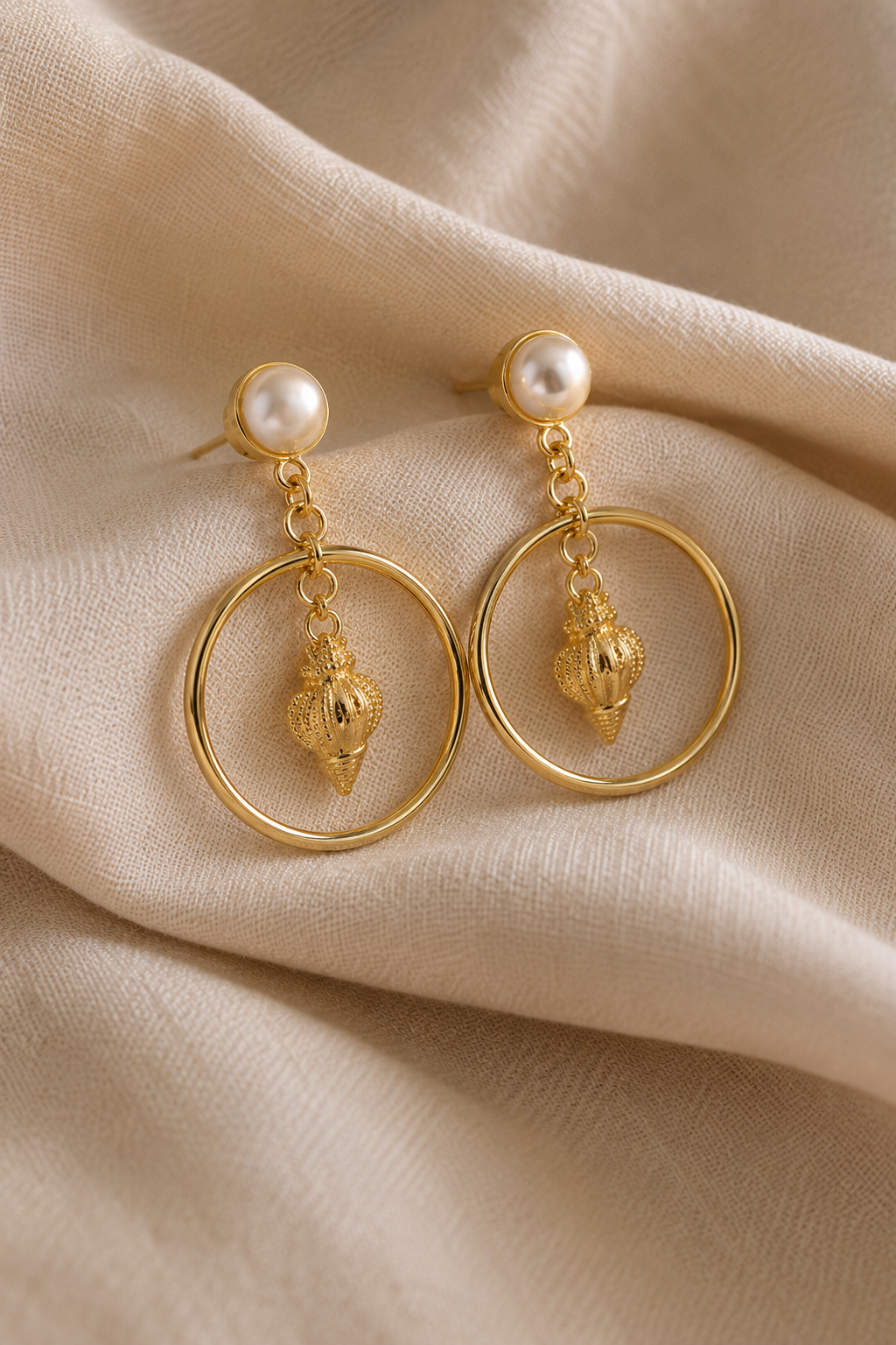 Seashell Pearl Drop Earrings shown flat on fabric